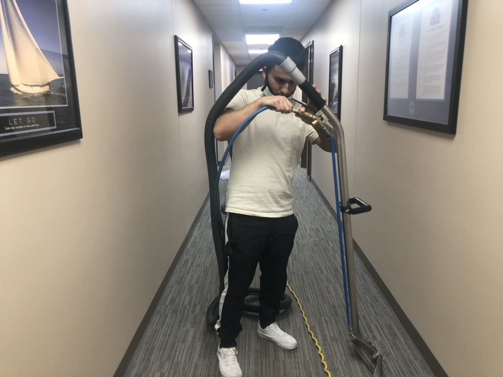 Professional carpet extraction equipment in use at St. Louis office building