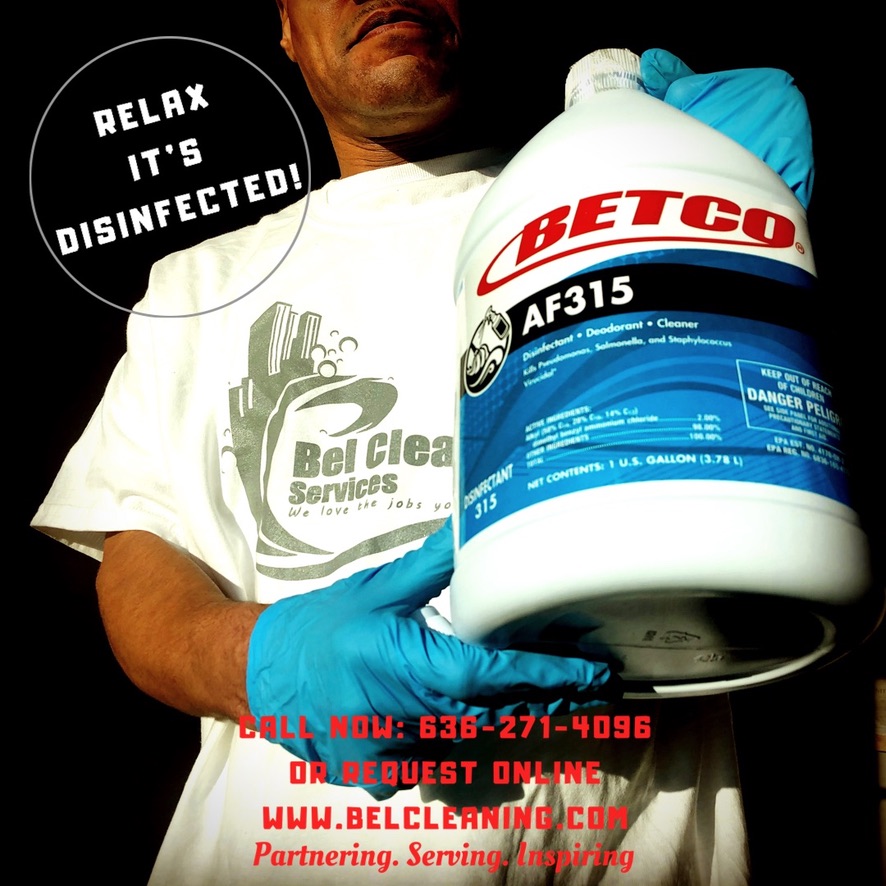 Bel Cleaning team member with professional glass cleaning squeegee and BETCO Clear Image cleaner