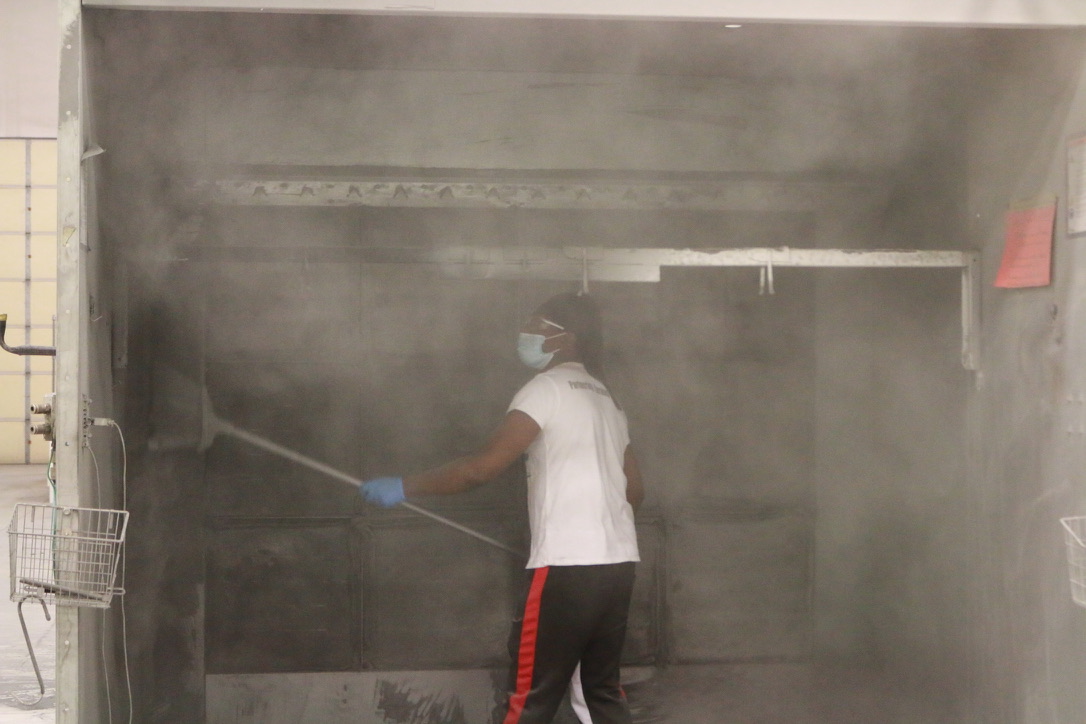 Bel Cleaning technician performing a paint booth deep cleaning at a Missouri manufacturing plant