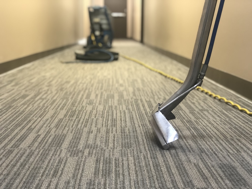 Close-up of Bel Cleaning steam carpet extraction wand on office carpet tile